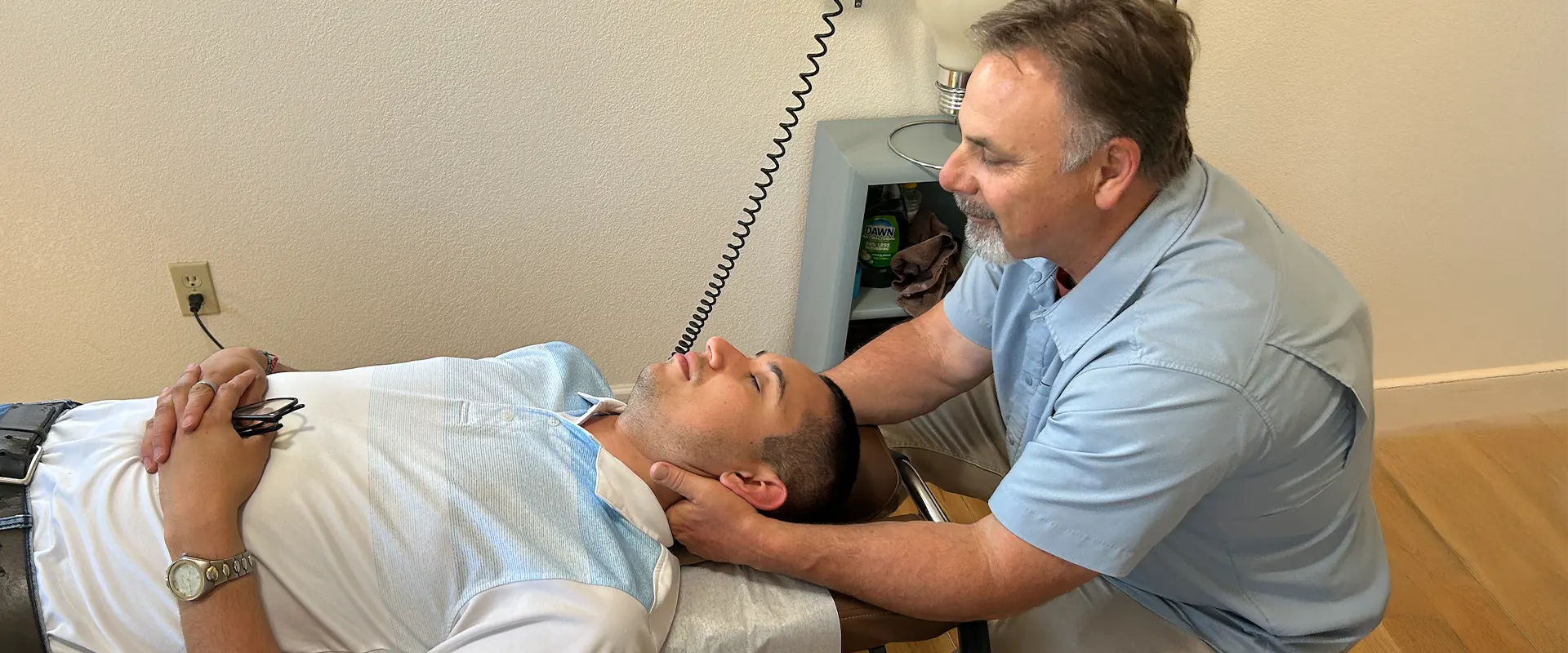 Chiropractor Dr. Richard Doble performing a precise upper cervical neck adjustment on a patient in Sebastopol CA