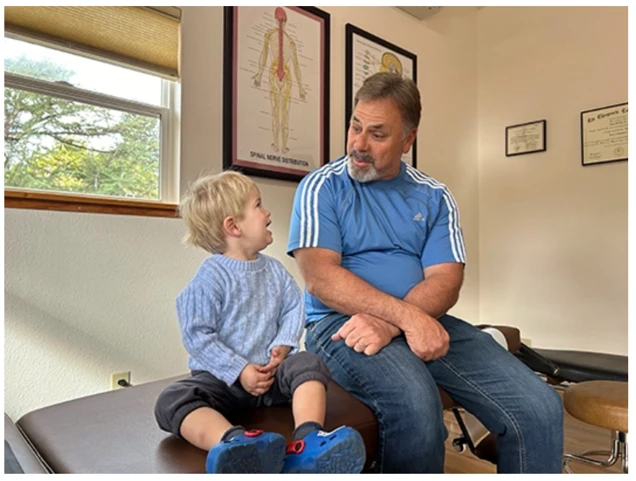 Chiropractor Sebastopol CA Richard Doble Joking with a Young Patient